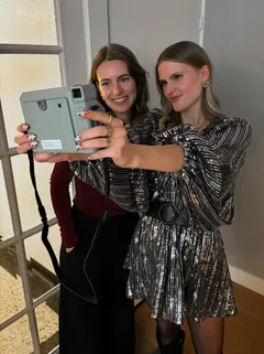 Twee vriendinnen maken een selfie met de polaroid camera